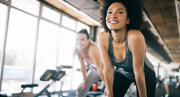 Woman smiling in workout class using weight loss program